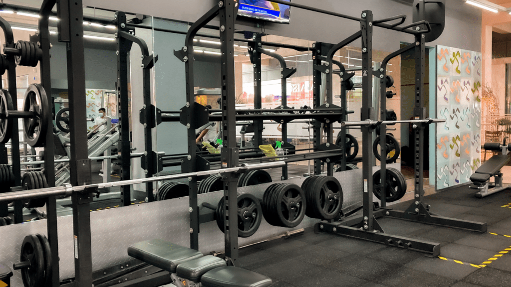 a gym with weights and equipment in the middle of the room