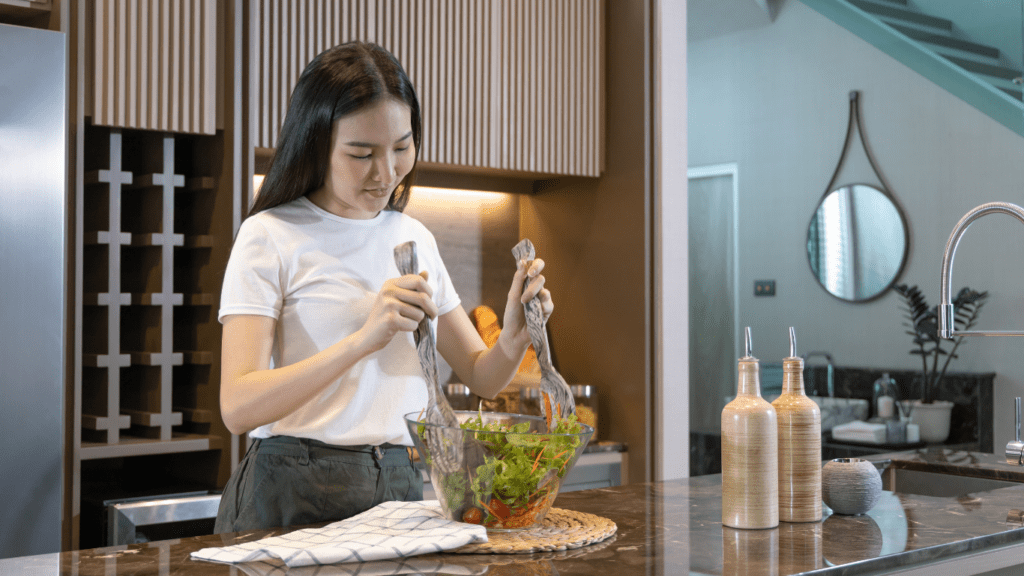 A person preparing salad in the kitchen 