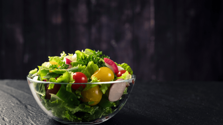 salad in a glass bowl on a dark table