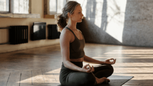 a person is sitting in the middle of a yoga pose