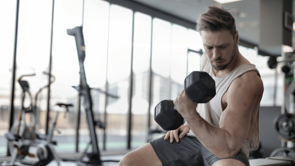 a person is sitting on a bench in a gym