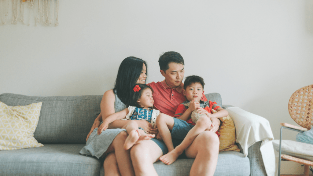 a family sitting on a couch in a living room