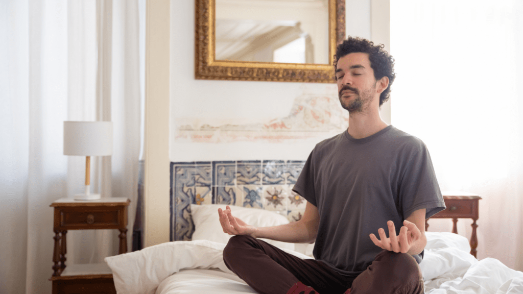 Someone meditating on a bed