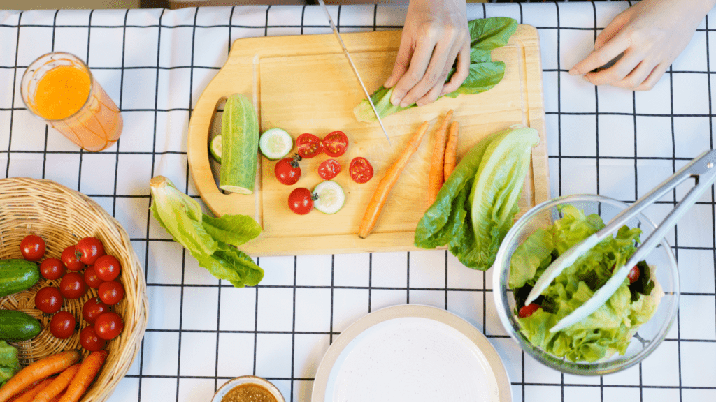 people cutting vegetables on a cutting board