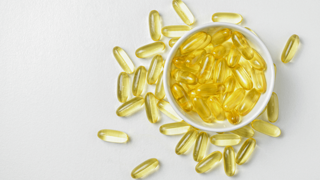 a bowl full of fish oil capsules on a white surface