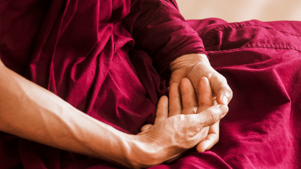 a buddhist monk meditating in the forest