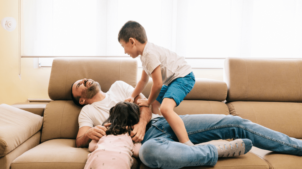 a family sitting on a couch in a living room