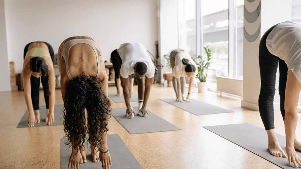 a group of people doing yoga in an indoor gym