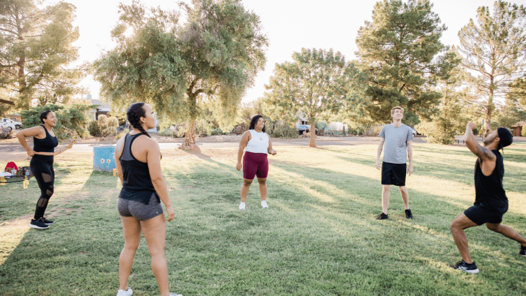 a group of people playing frisbee in a park