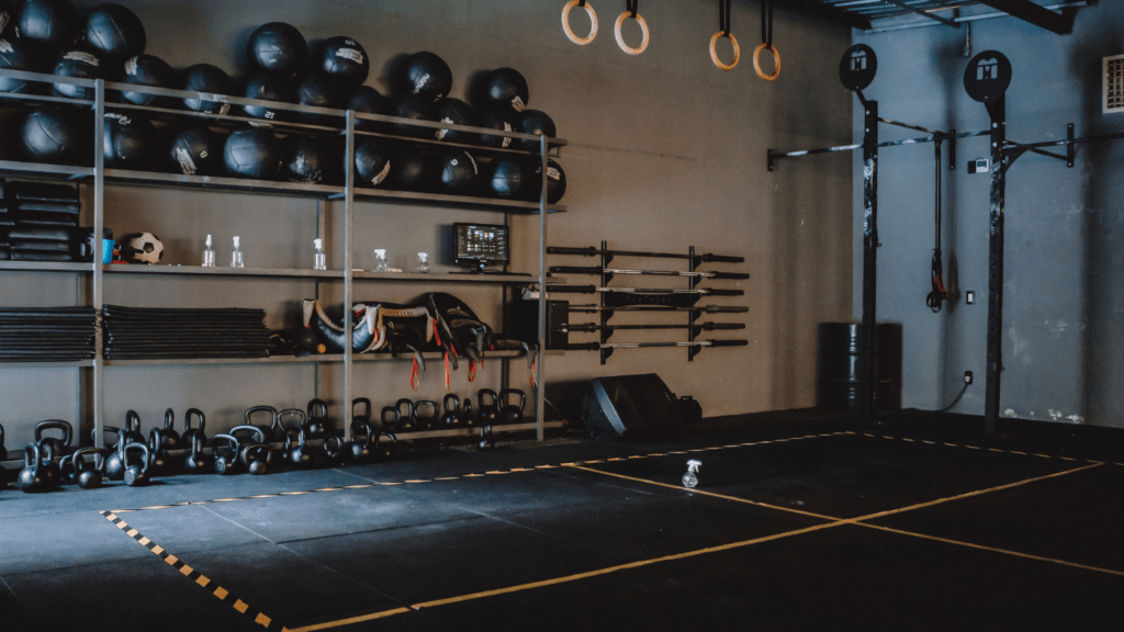 a gym with weights and equipment in the middle of the room