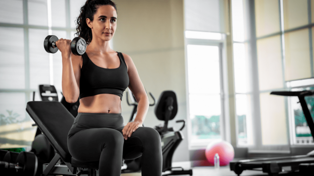 a person is sitting on a bench in a gym