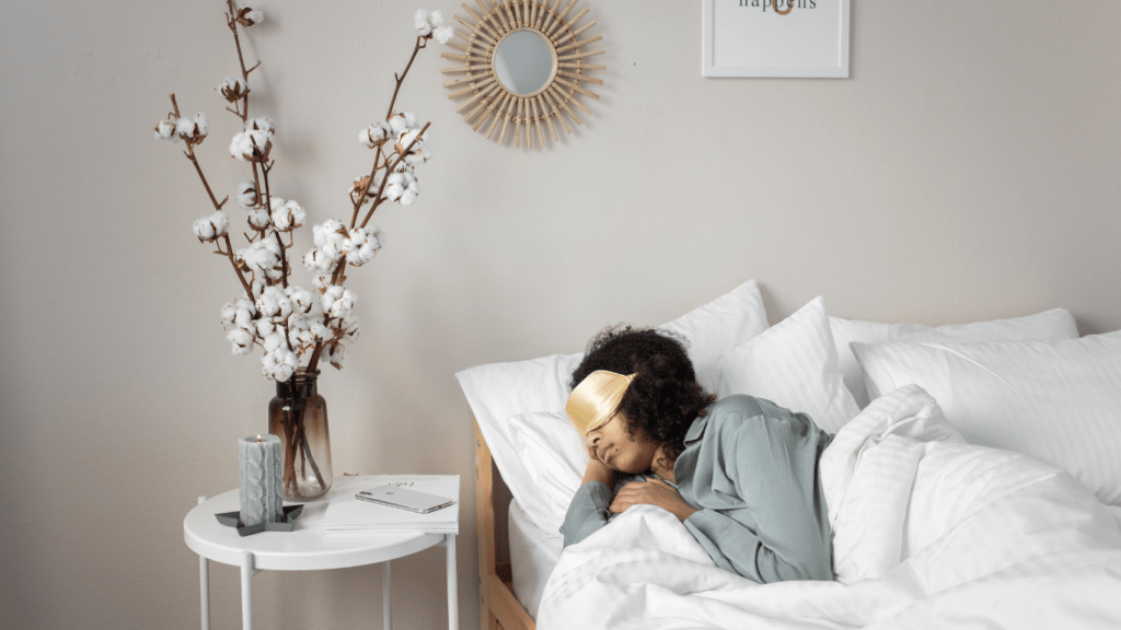 a person sleeping in bed with a white pillow