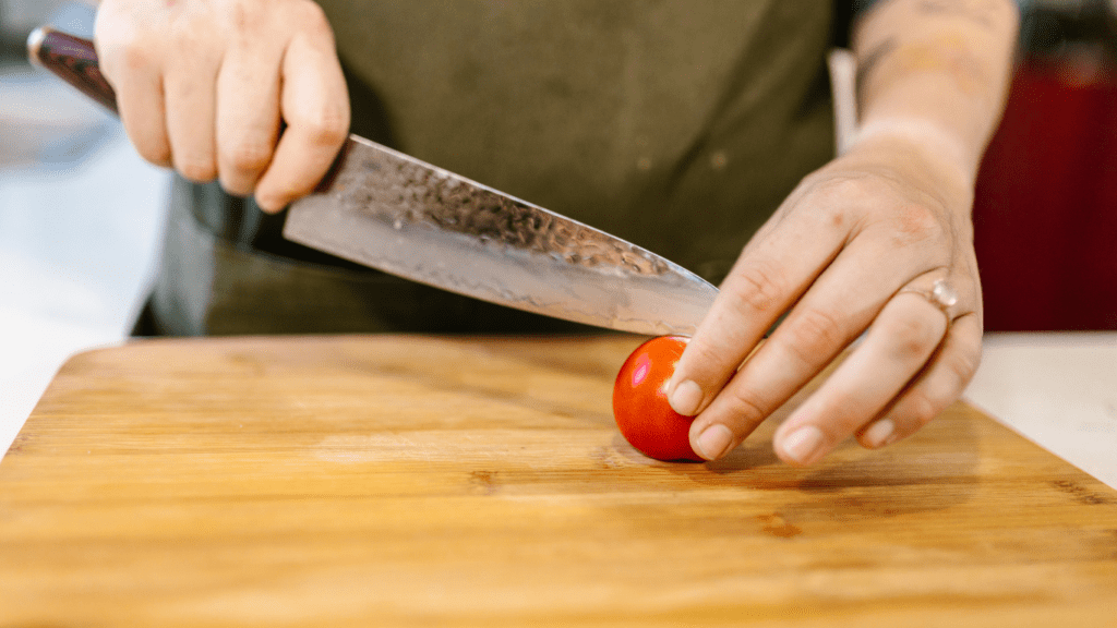 people cutting vegetables on a cutting board