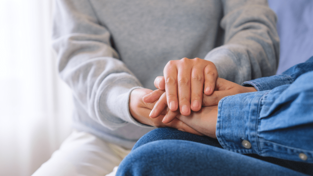 two people shaking hands in a park