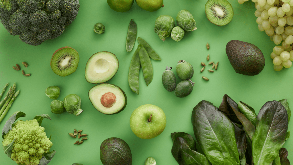 various fruits and vegetables on a green background