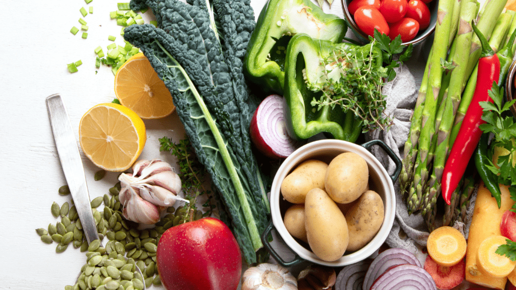 various vegetables and fruits are arranged on a table